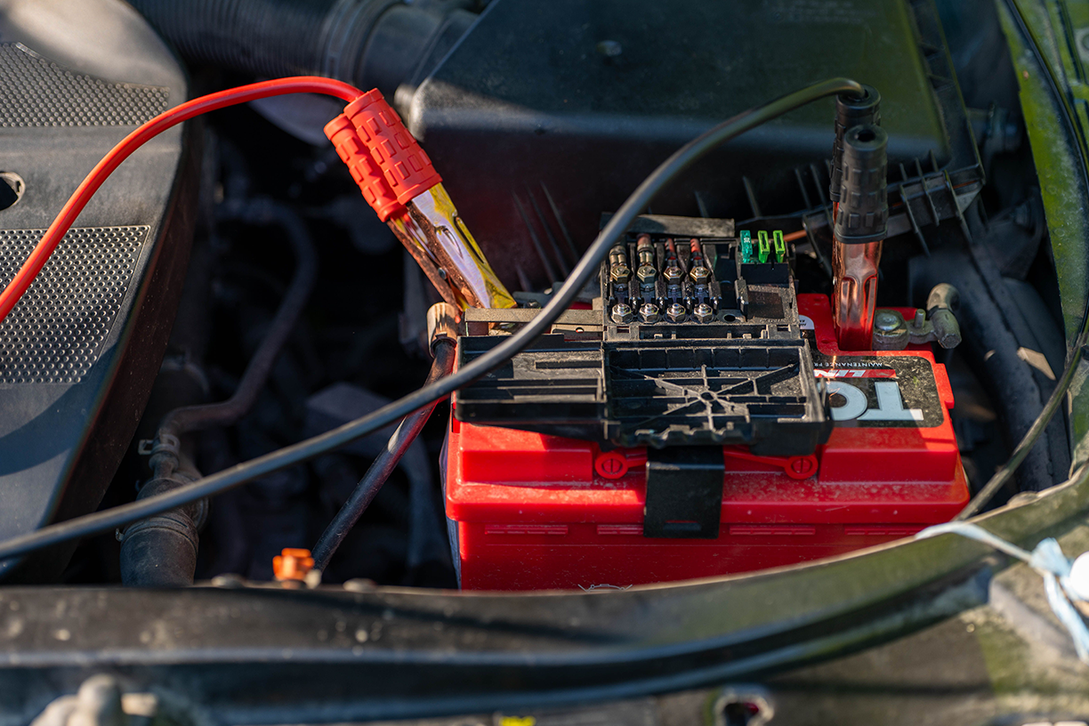 Car battery with jumper cables attached