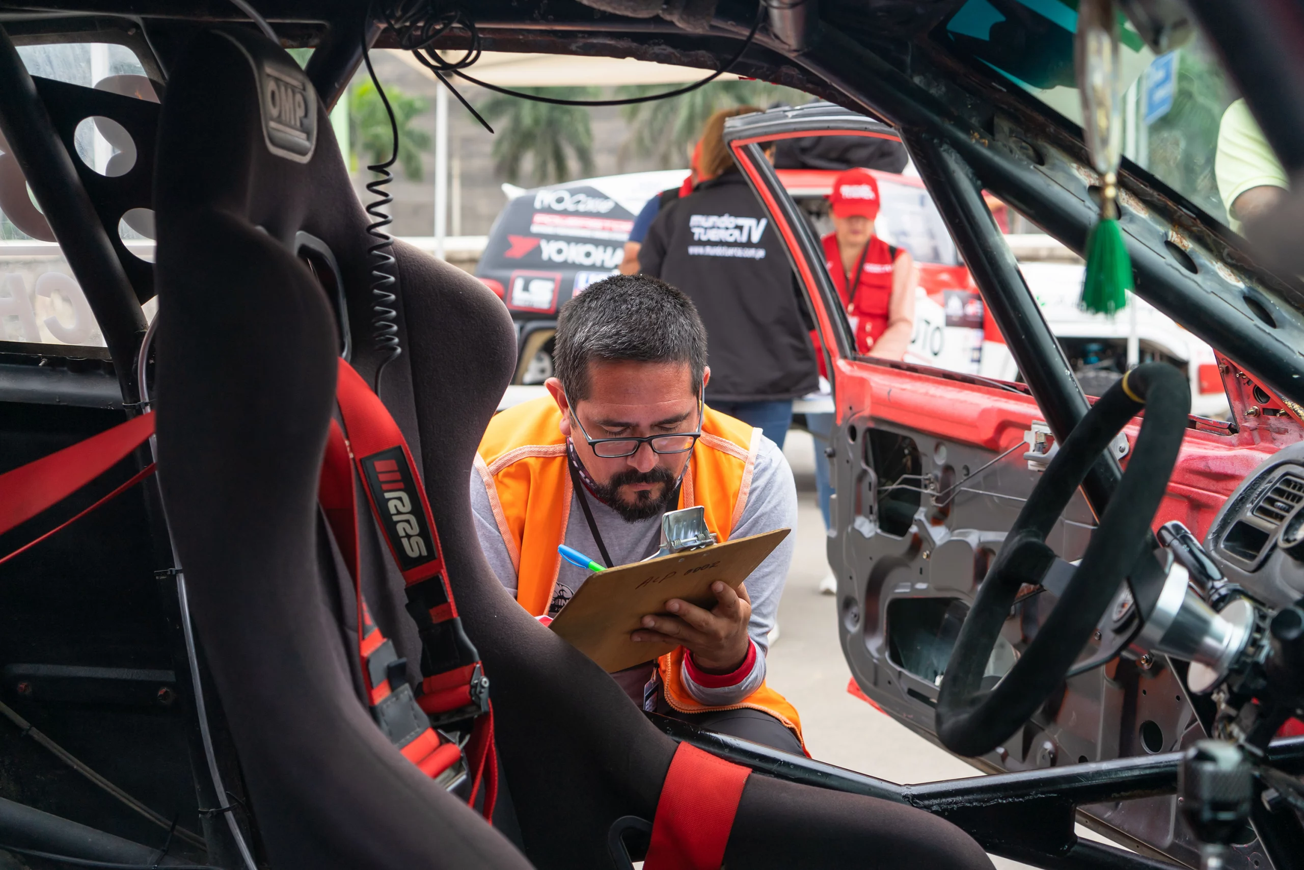 Technician performing a summer vehicle maintenance inspection
