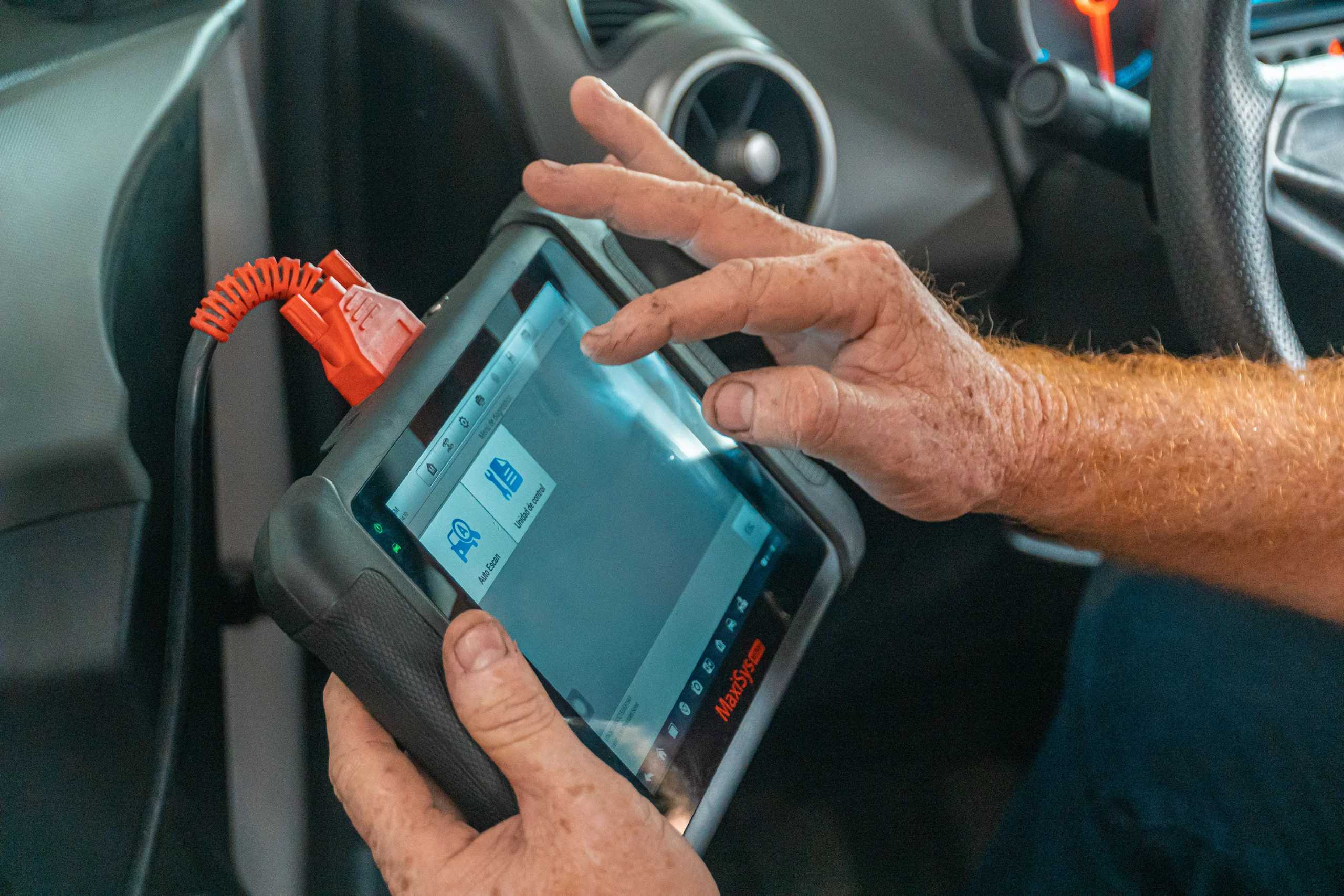 Technician using a diagnostic tool on a vehicle