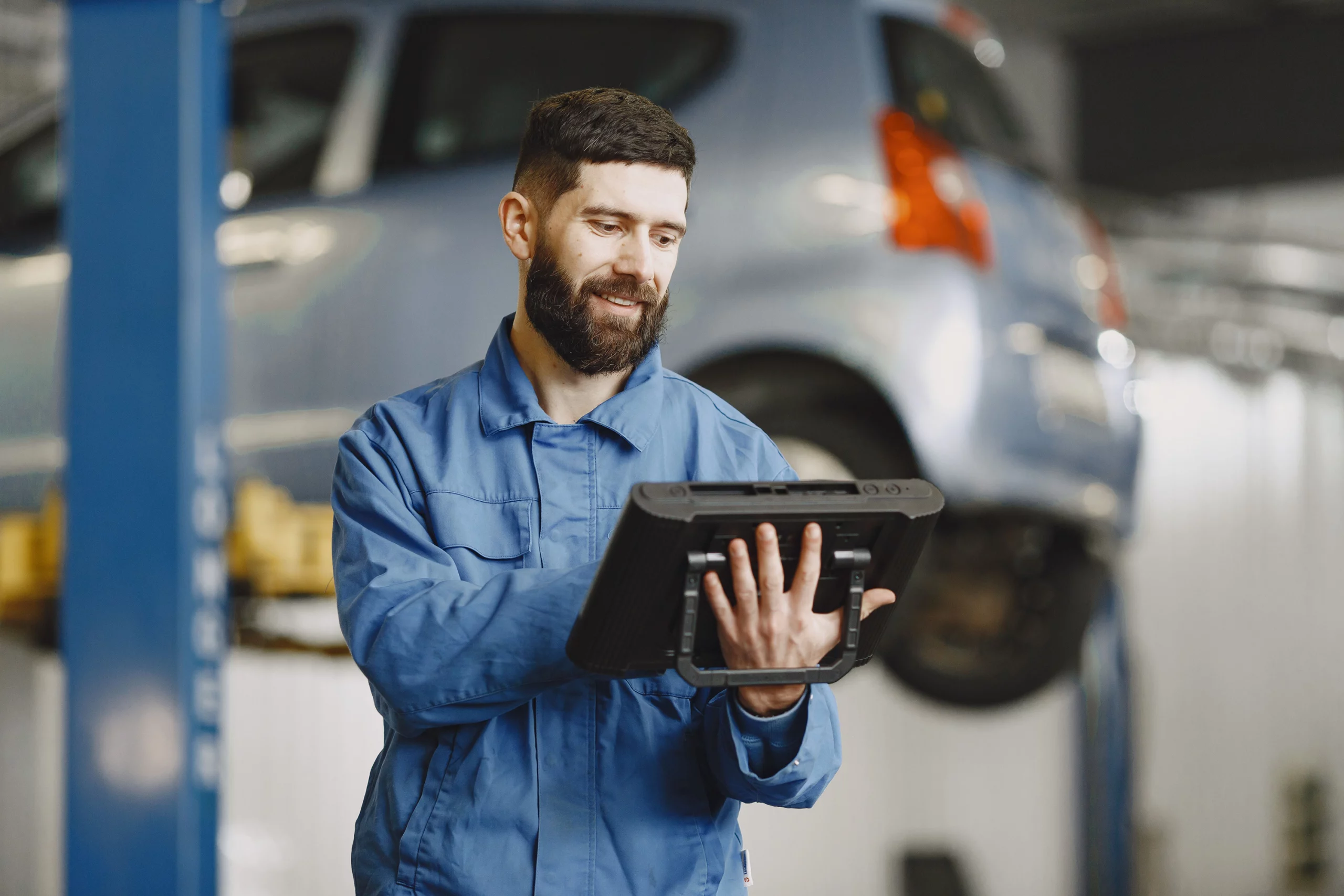 Mechanic holding a digital tablet running vehicle diagnostics