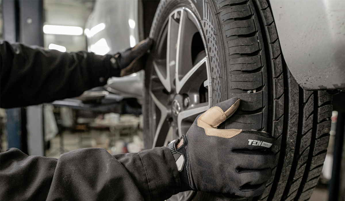 Technician inspecting a tire during a safety check