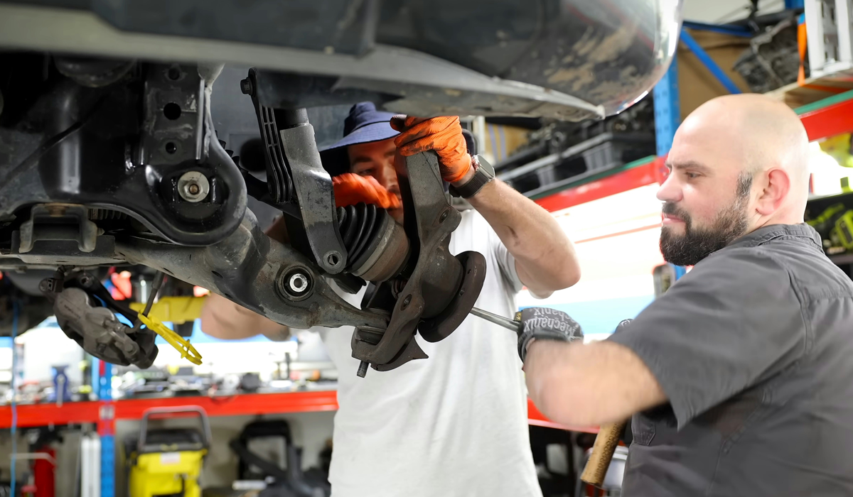 Technician working on a vehicle's suspension