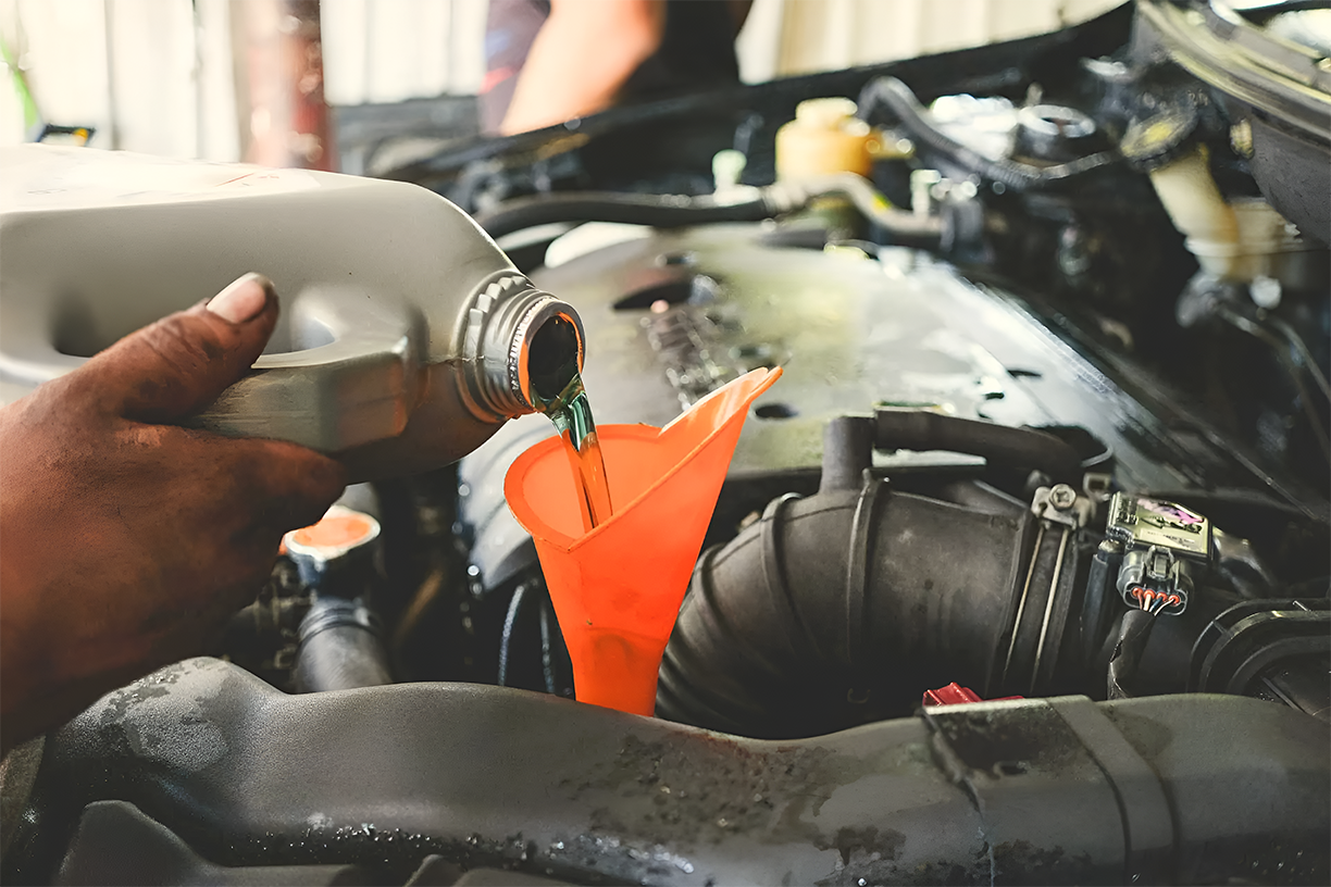Mechanic performing a professional transmission fluid replacement.