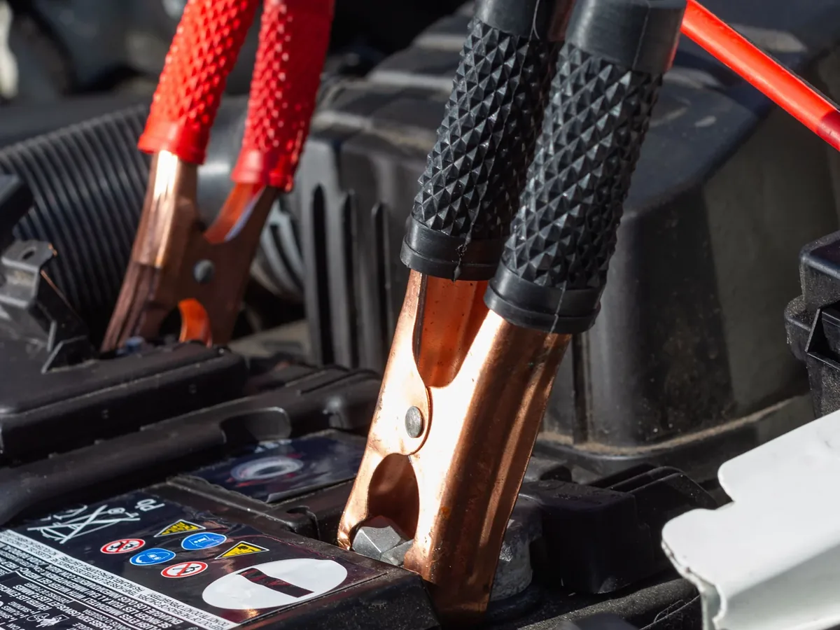 Jumper cable clamps on a car battery
