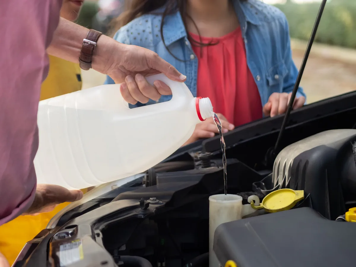 Topping up engine coolant during a cooling system check