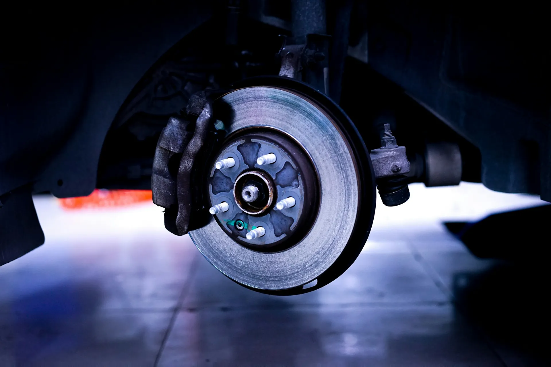 Brake disc and caliper on a car with the wheel removed