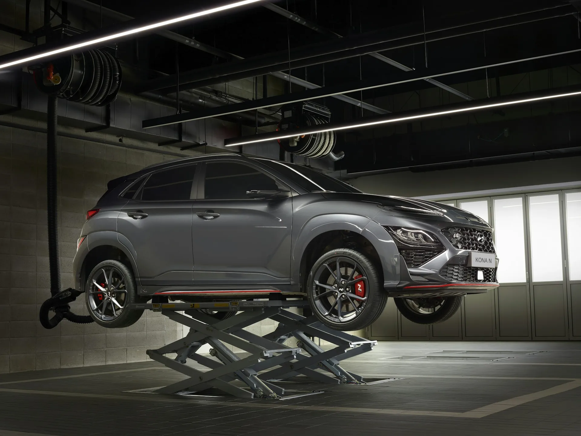 Car raised on a lift in a modern auto repair garage