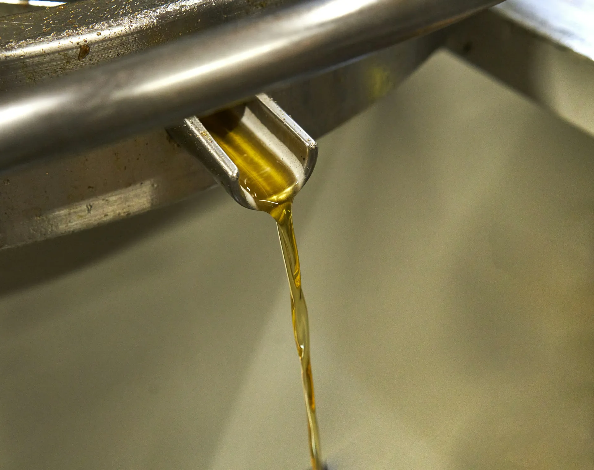 Golden motor oil pouring from a spout